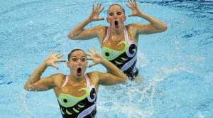 Two synchronised swimmers coming out of the water